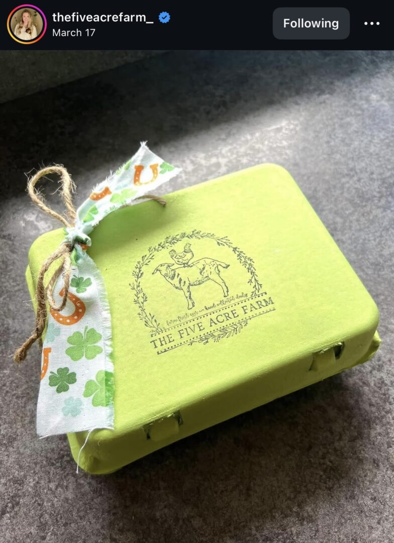 Green box with decorative ribbon and logo.