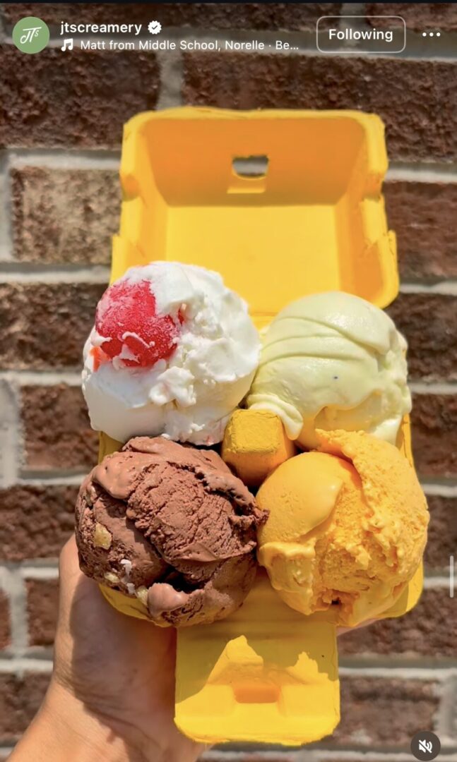 Four ice cream scoops in yellow container.